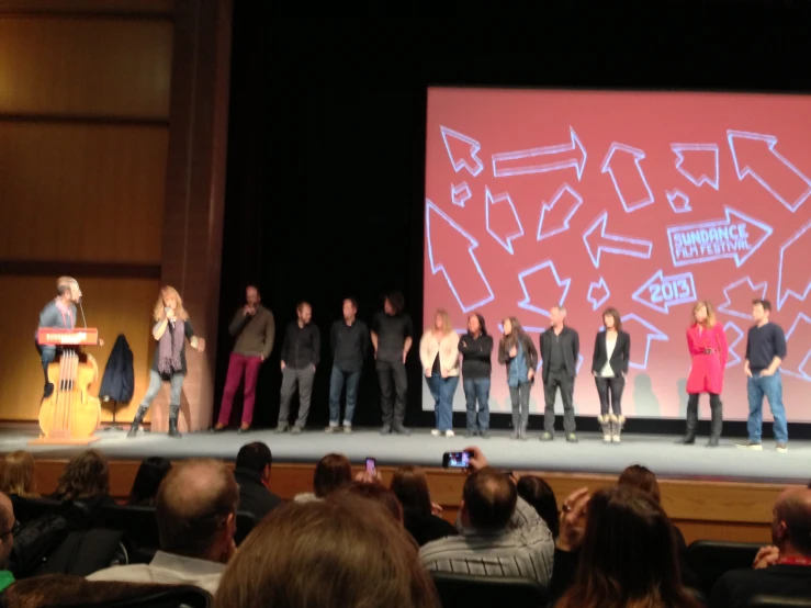 a number of people on stage at a festival