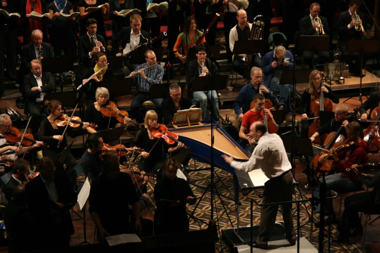 conductor and orchestra playing music at an indoor concert