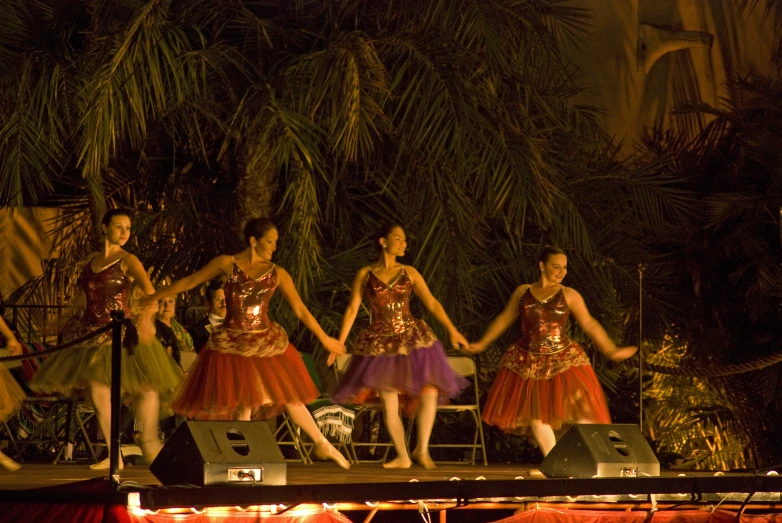a bunch of girls in dress performing on stage
