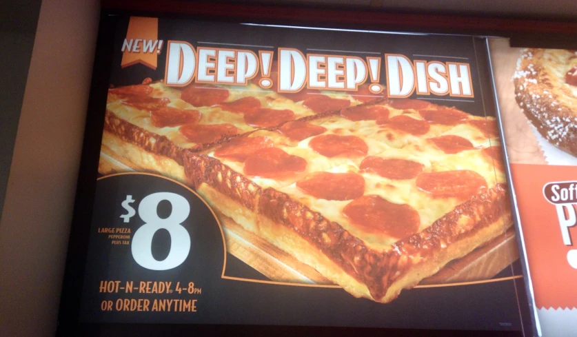 a large pizza advertit with a giant piece of pizza