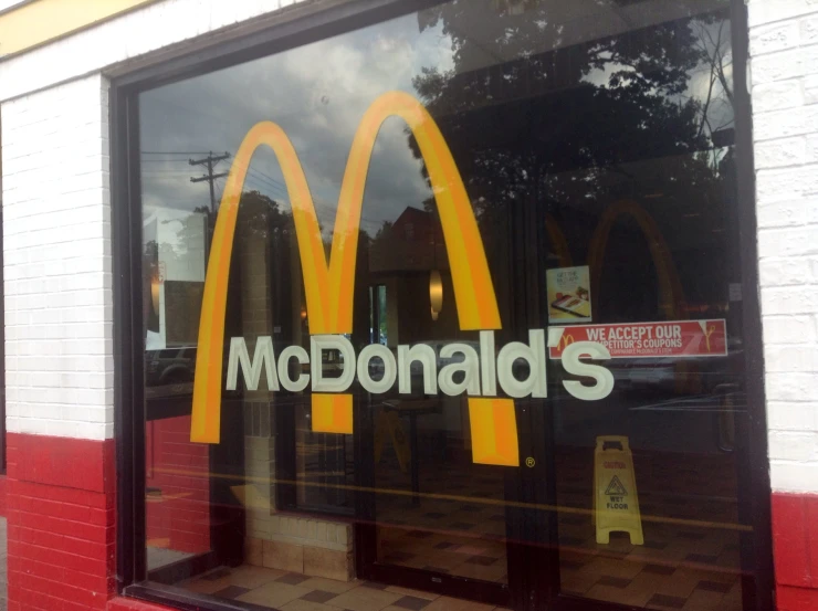 the reflection of a mcdonald's logo in a glass window