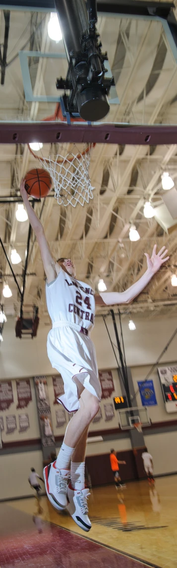 a man who is leaping up to dunk a basketball