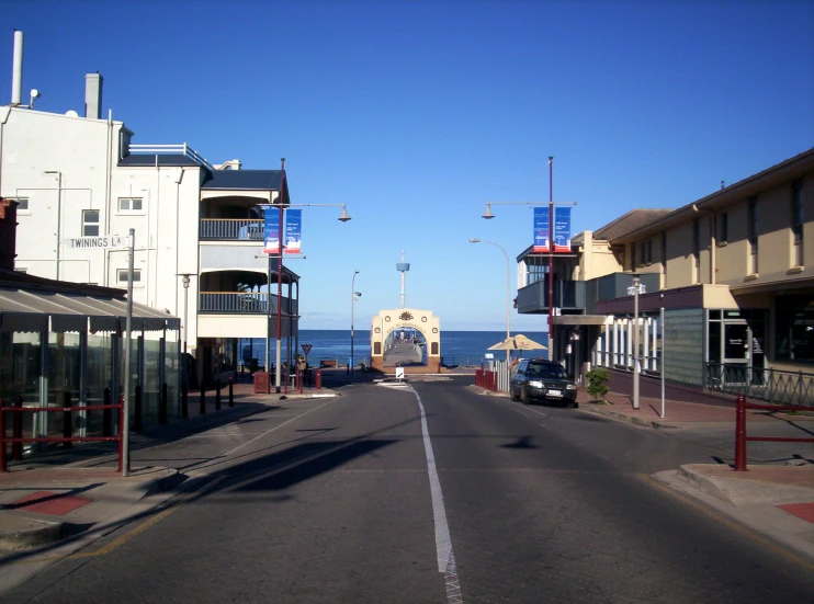 cars are parked along the beach in the city