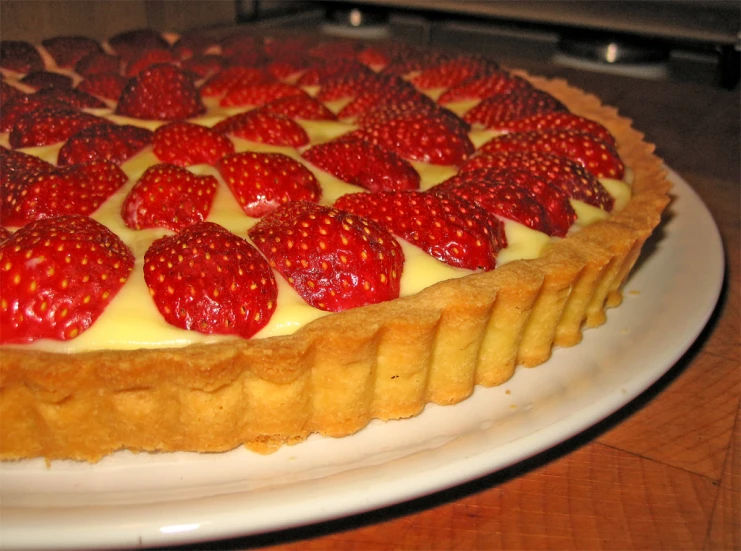 strawberry cheesecake on a white plate is ready to be eaten