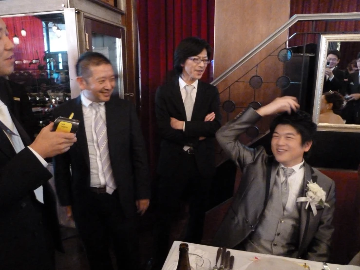 two men in suits having fun at a formal event