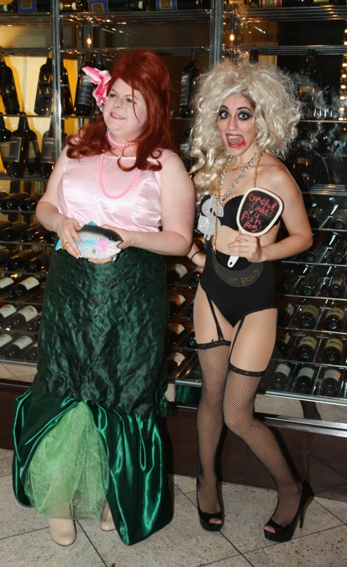 two ladies are dressed as the mermaids