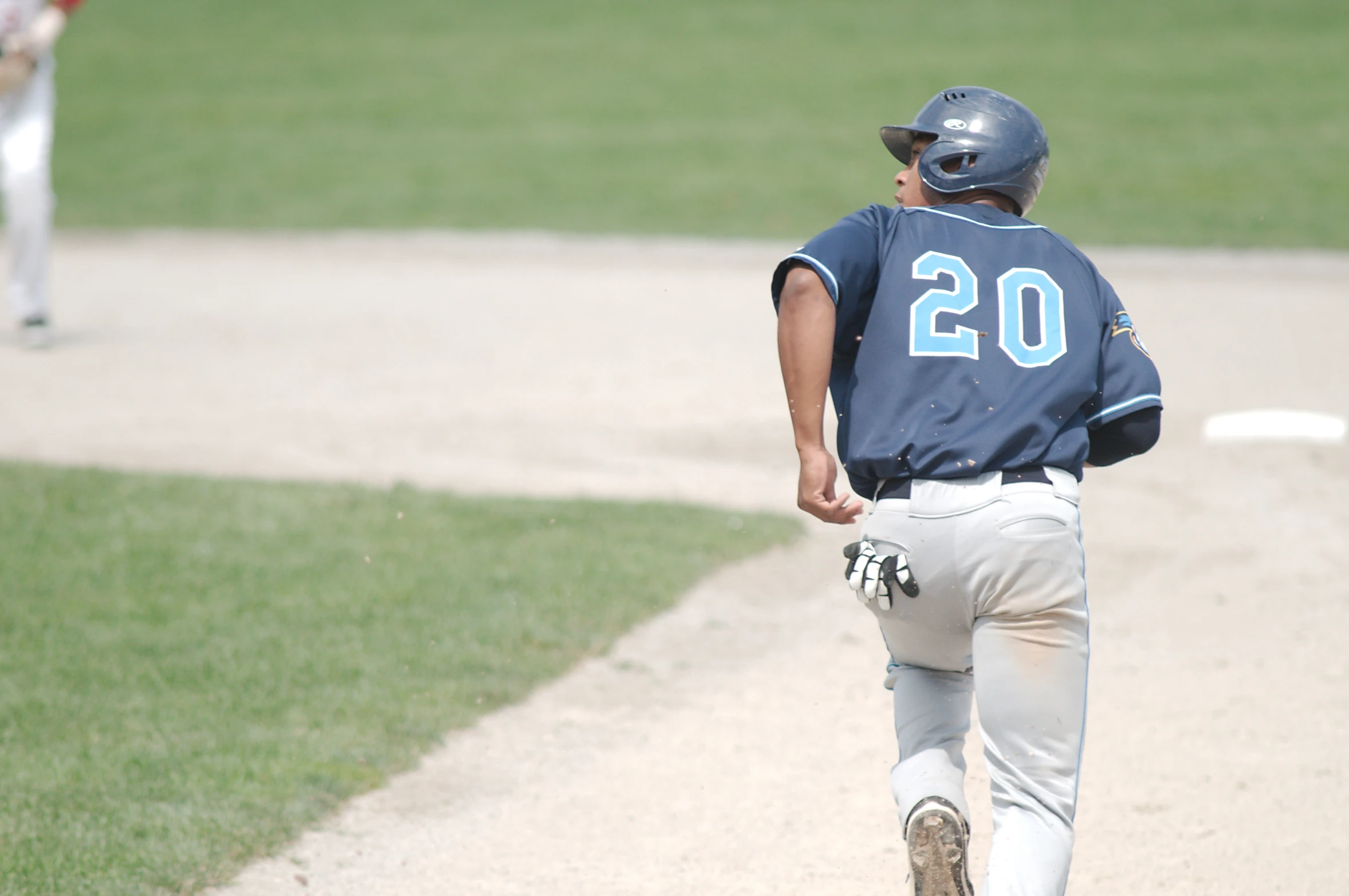 a baseball player walking towards home plate