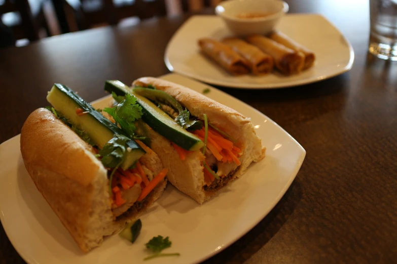 a sandwich with vegetables on a white plate