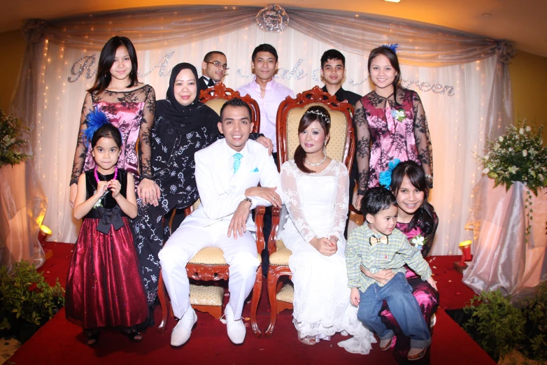 the bride and groom are surrounded by children