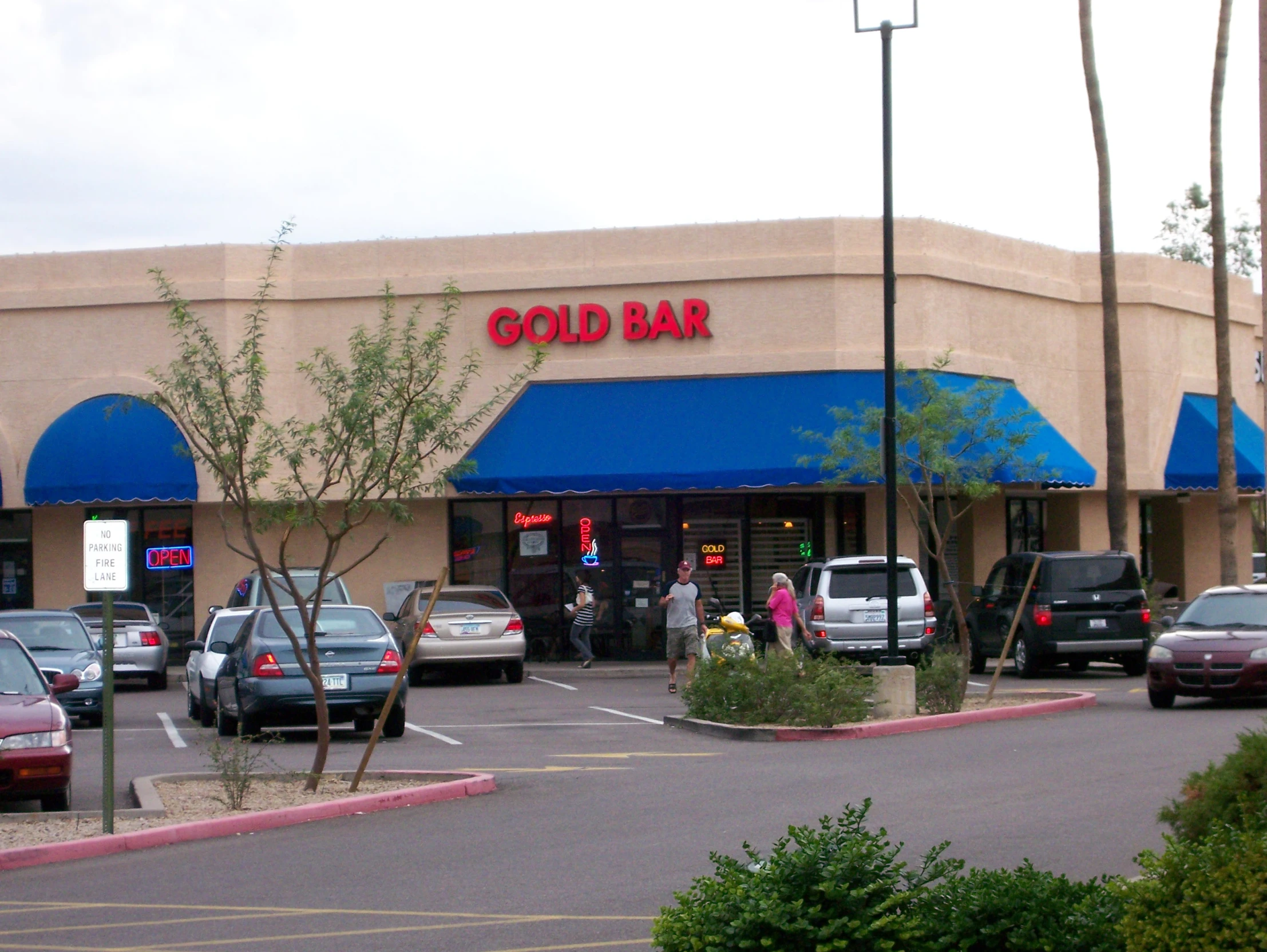 people are entering a cold bar with cars parked in front