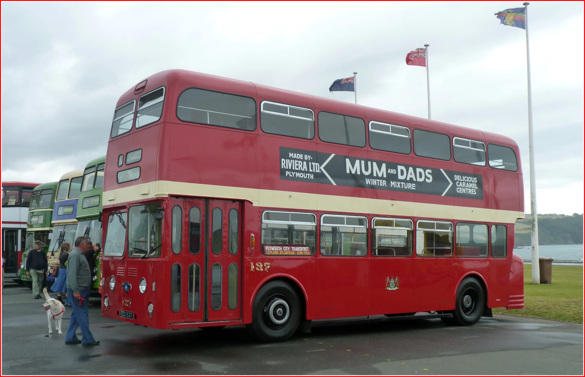 two double decked red buses parked next to each other