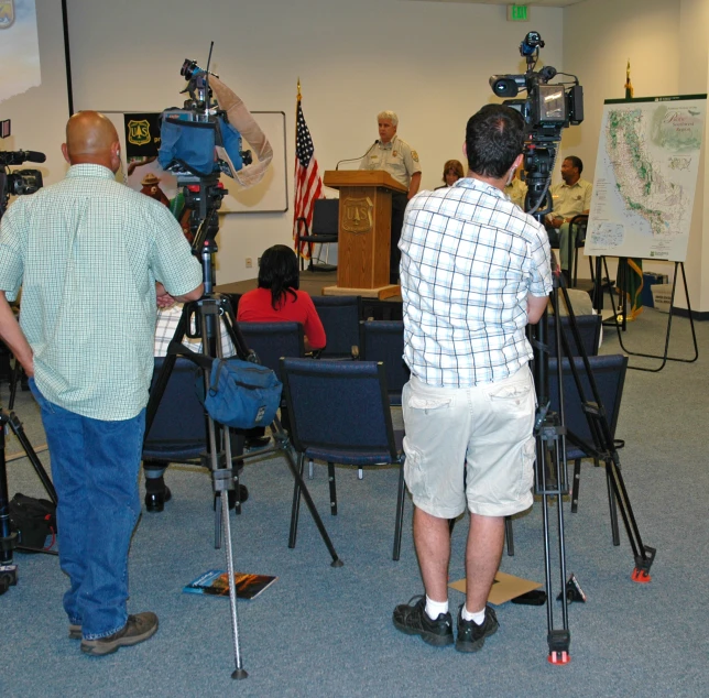 two men standing next to each other on a floor with microphones