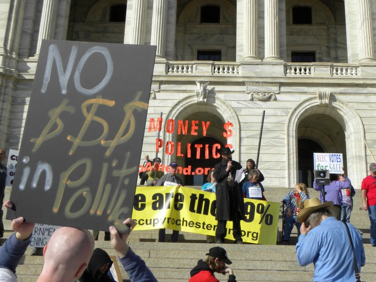 group of people holding protest signs at political event