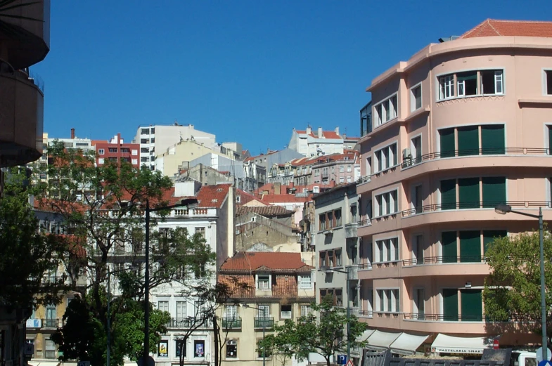 several buildings in a city with balconies on top