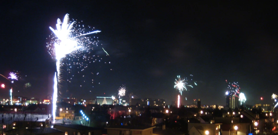 fireworks are lit up in the night sky on a city