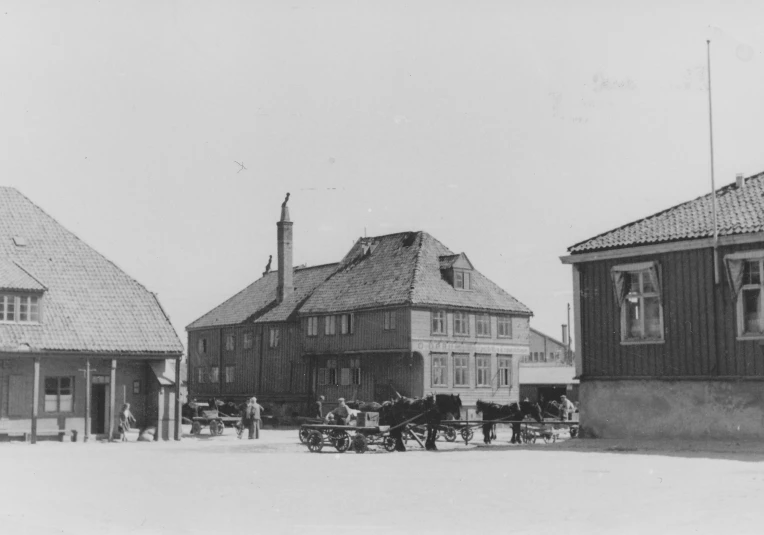 old fashioned town with some horses pulling carriages