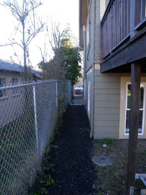 an empty pathway leads to the back of an apartment