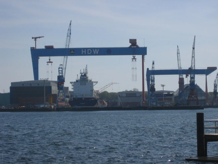 a large crane on a body of water near the dock