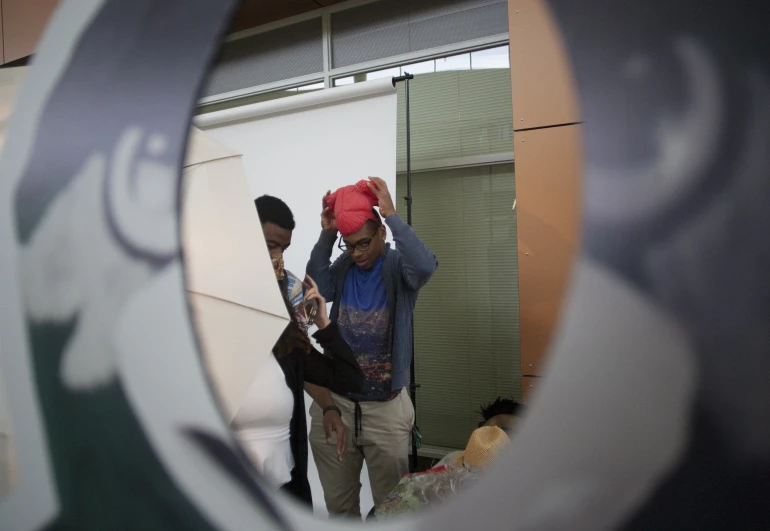 a man and a woman in the mirror with a surfboard