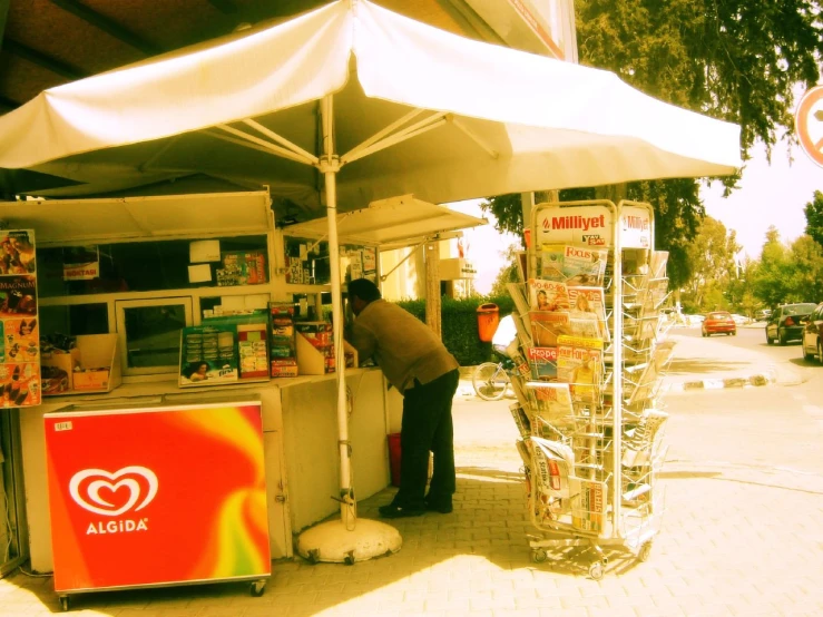 a man buying a slice of pizza at a booth