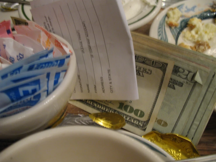 dollars and money sit in bowls and dishes