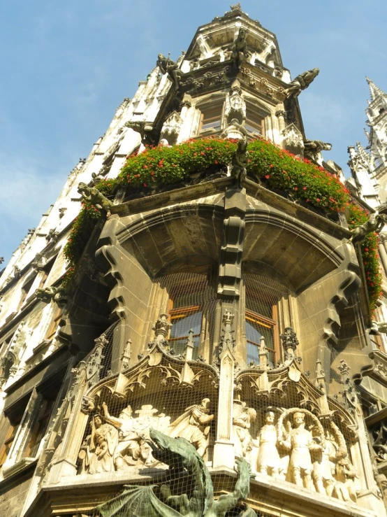 the ornate architecture of the building has green flowers in it