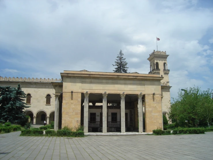 an ancient building sitting in front of a park