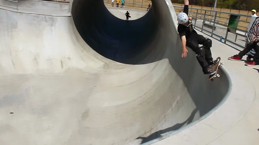 a person skateboarding near a ramp at a skate park