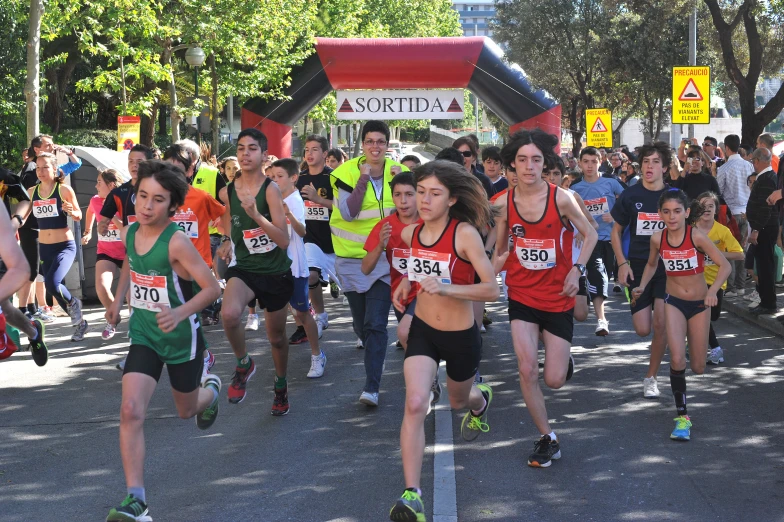 a group of young people running down the street