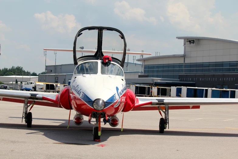 a small airplane on a airstrip with an awning in front