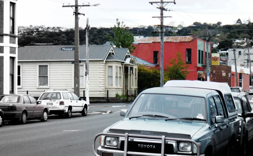 a truck and cars sit in traffic on the street