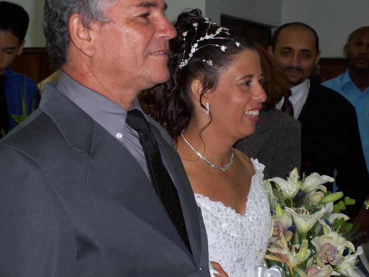 a man and woman smile as they stand together