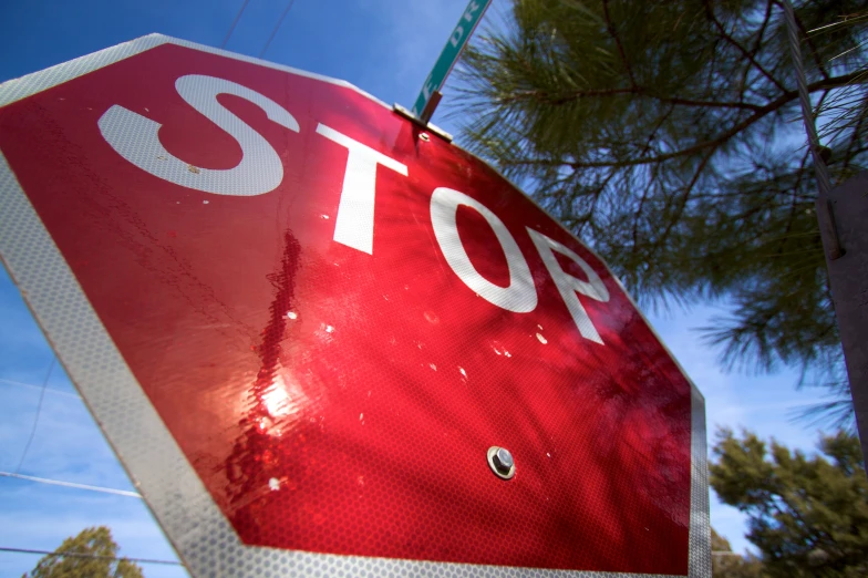 a stop sign has been bent over to expose the corner