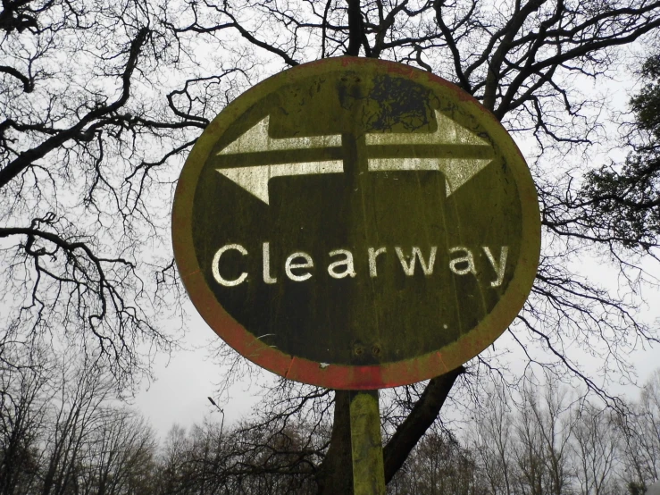 a wooden sign shows the direction to clear way