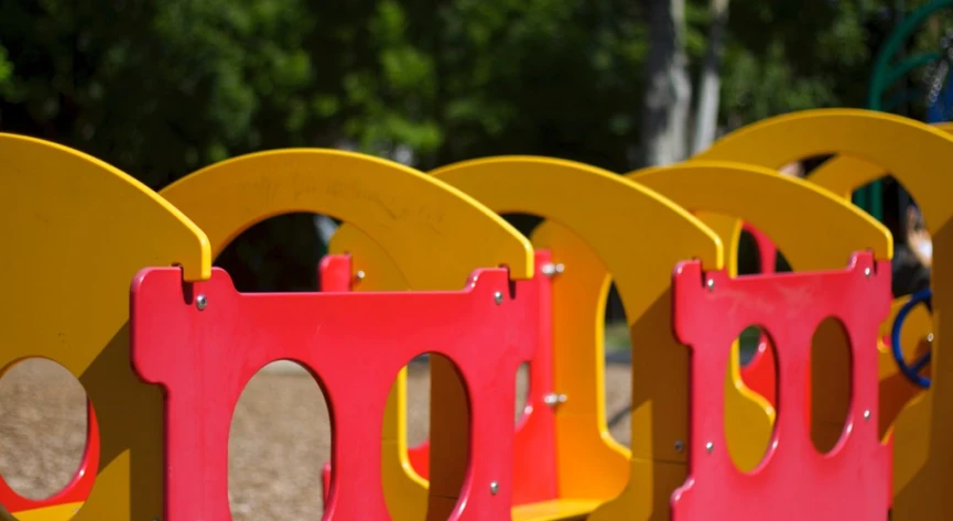 a row of plastic yellow and red seats next to each other