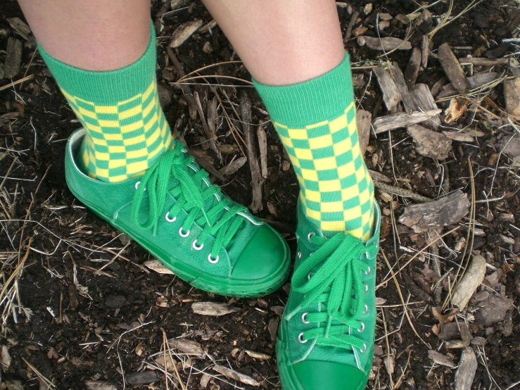 a woman in green converse sneakers wearing green socks