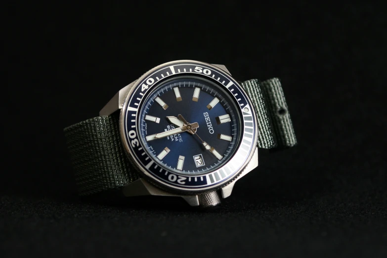 an image of a watch with a blue face on black background