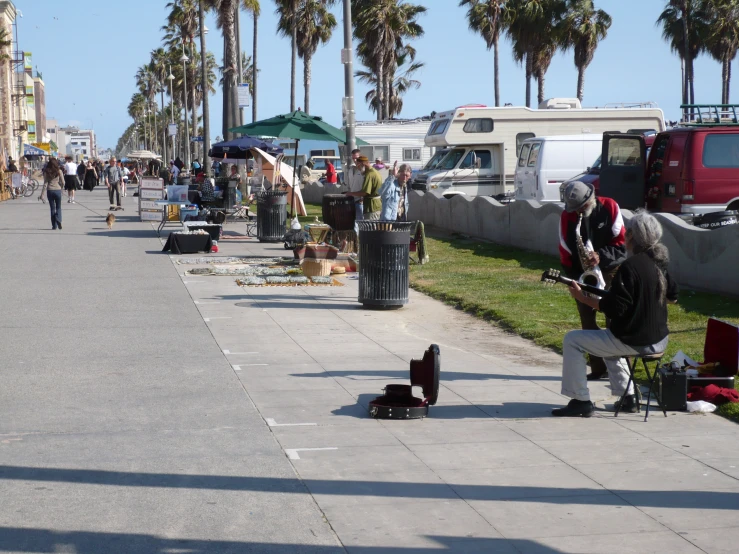 some people on some concrete near some palm trees