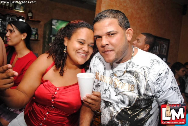 two people at a party are posing for the camera