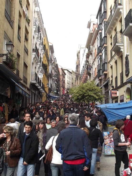 a large crowd of people are gathered outside a store