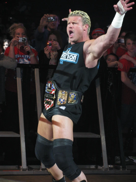 a man in his underwear throwing an object while wearing wrestling gear