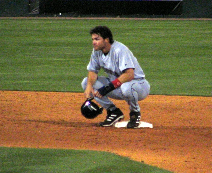 there is a man that is kneeling down on the field