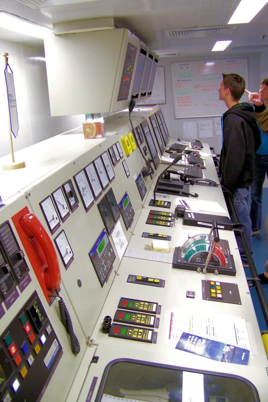 people viewing an equipment area in the space station