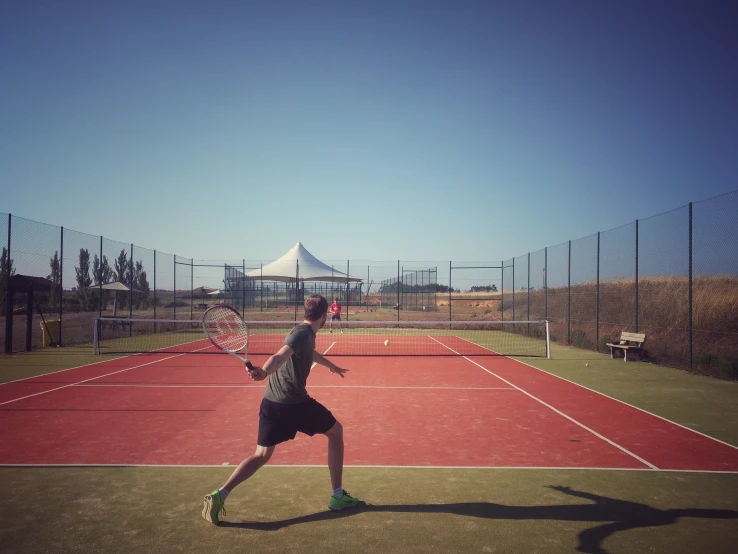 a tennis player swings at the ball on the court