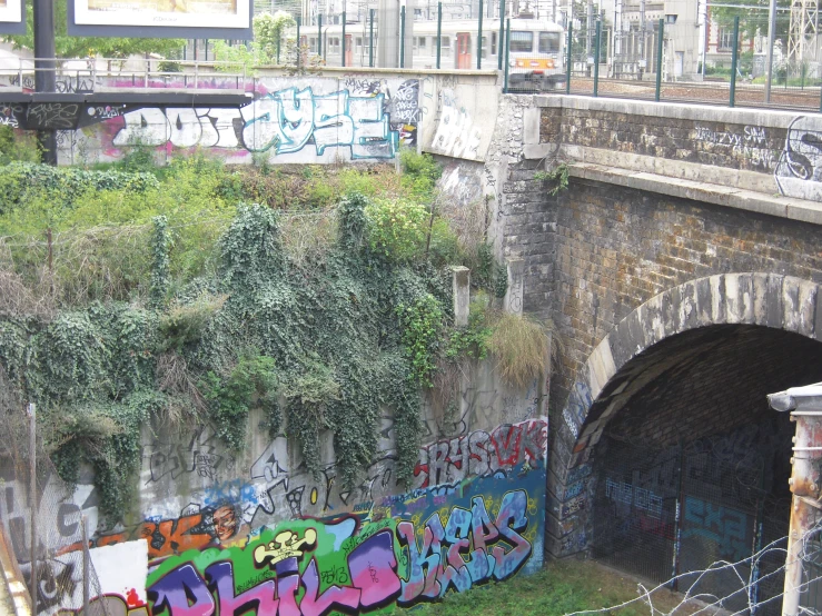 graffiti covers the walls and the side of a tunnel