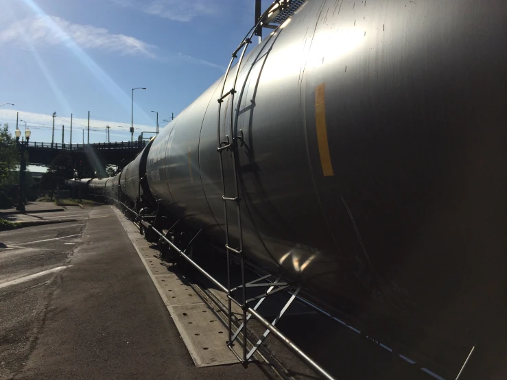 a tanker train parked next to an empty lot