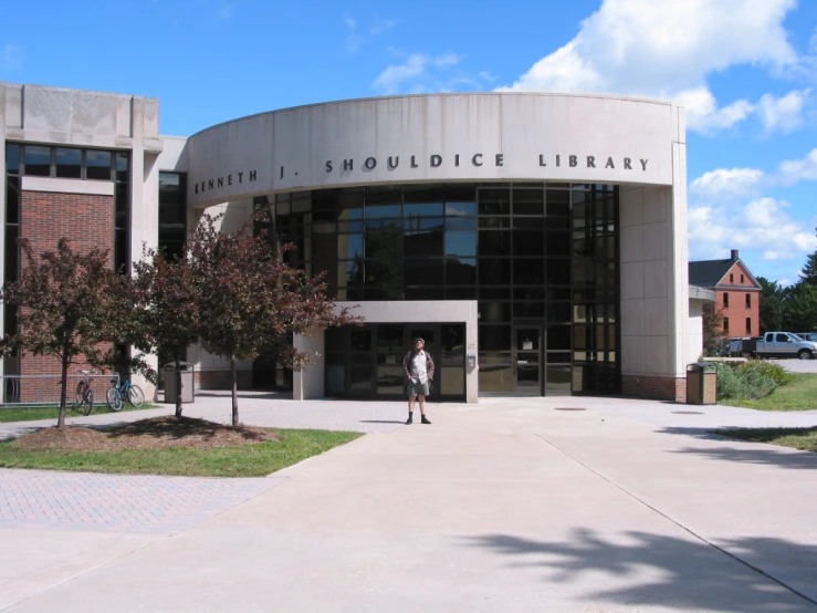 the view of the outside of an entrance to a building with a person in front