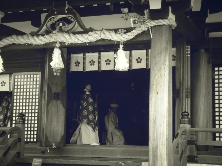 a woman is standing in the doorway with two other women