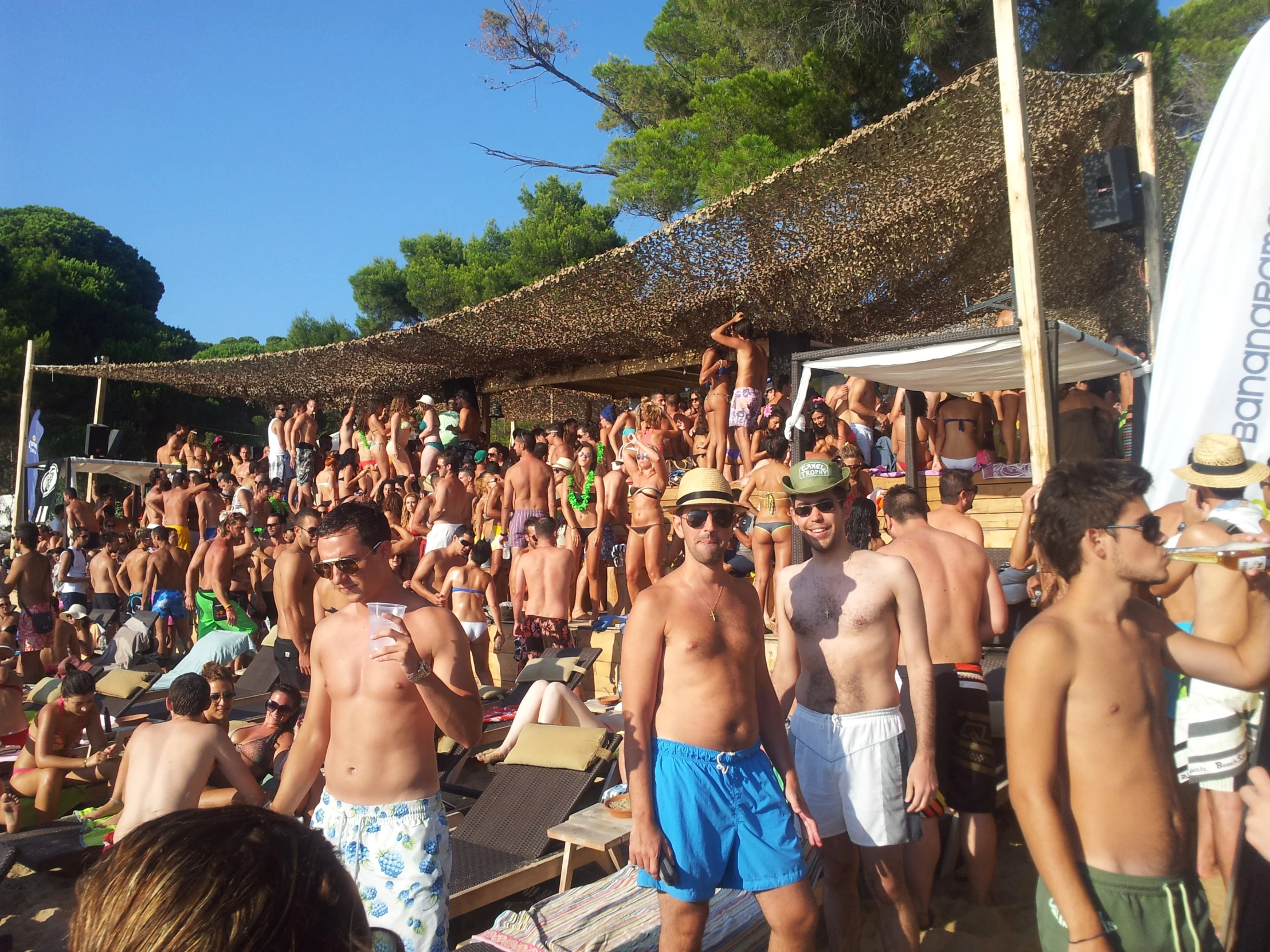 a group of people standing on top of a sandy beach