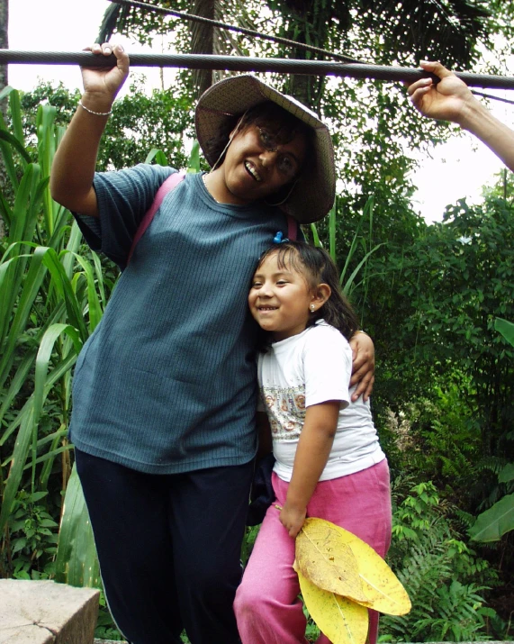 a woman holding onto her children while posing for a picture